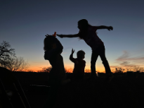 Sunset Silhouettes Playing on Haystacks