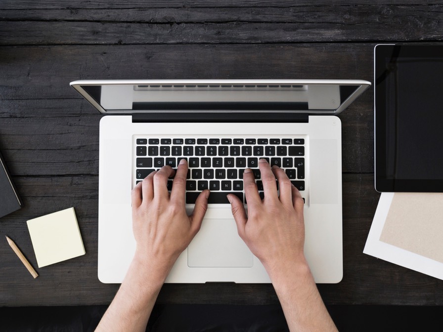 Image of person typing of laptop