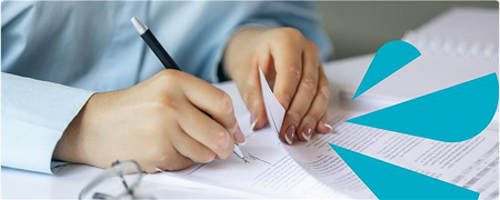 Image of person writing on documents