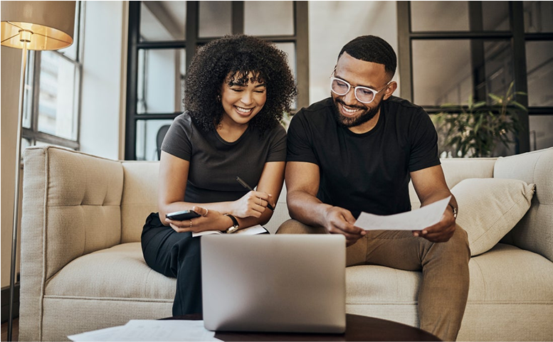 Image of two people looking at laptop