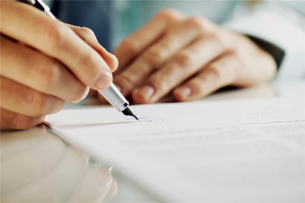 Image of person writing on document