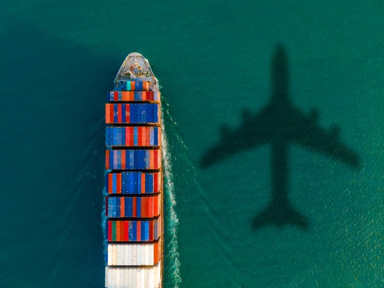 Image of cargo ship and airplane shadow