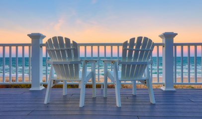 Image of two chairs facing beach